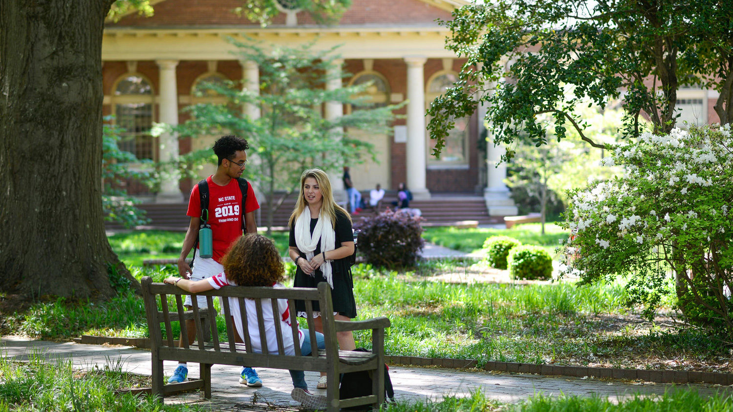 students talking on bench