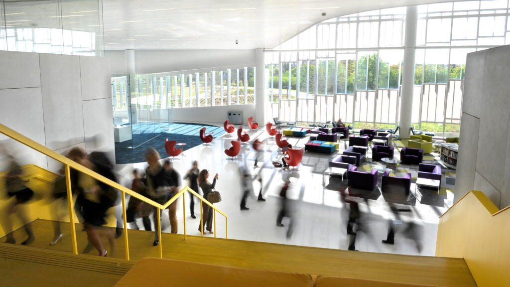 Students and patrons walk in the James B. Hunt Jr Library.