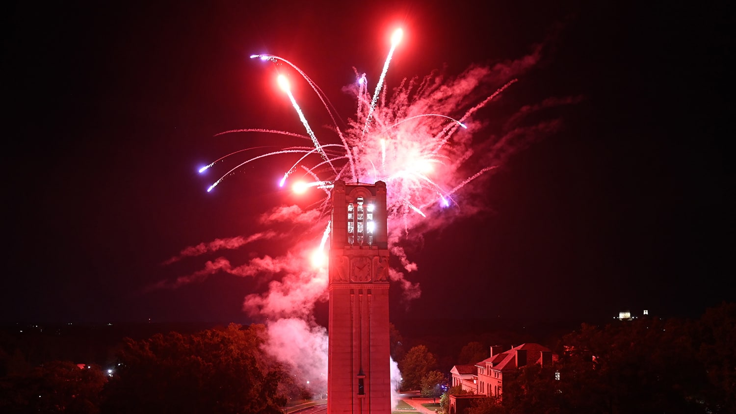 Fireworks explode over the NC State belltower