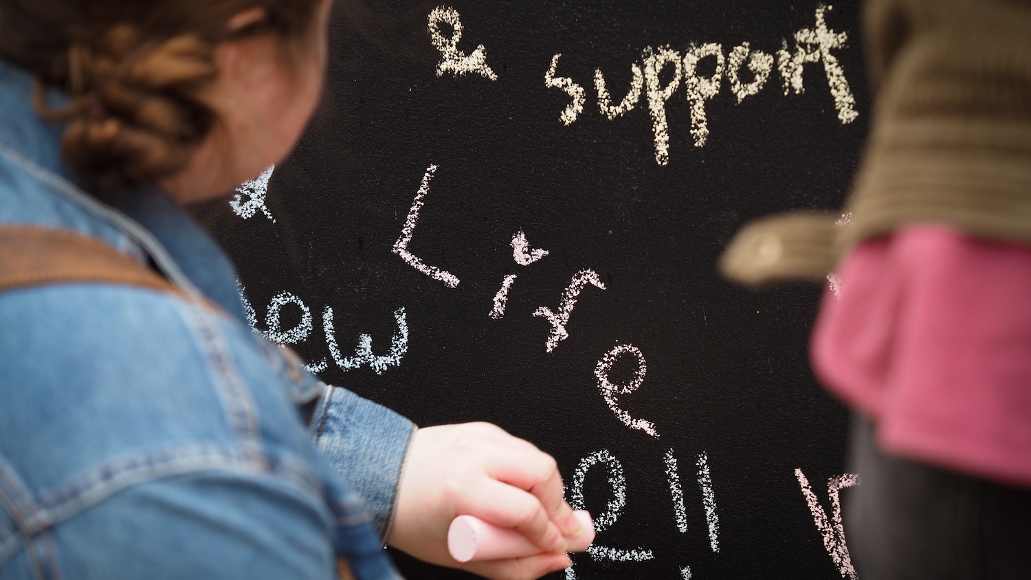 students writing on the Free Expression Tunnel