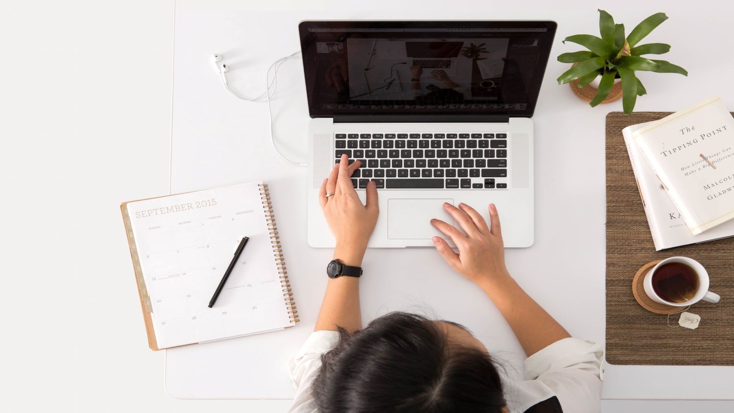 woman typing at a laptop